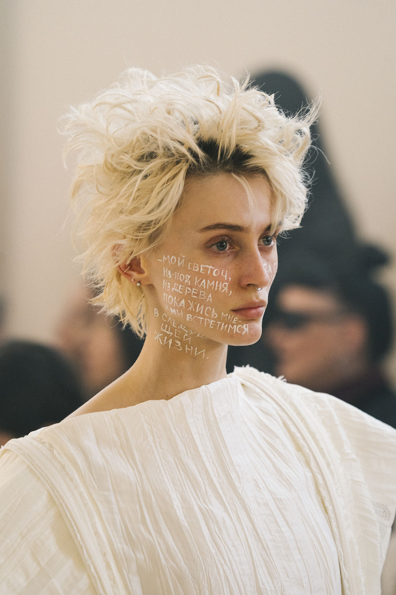 A close-up shows face lettering and a white pleated garment during DZHUS ANTICON.